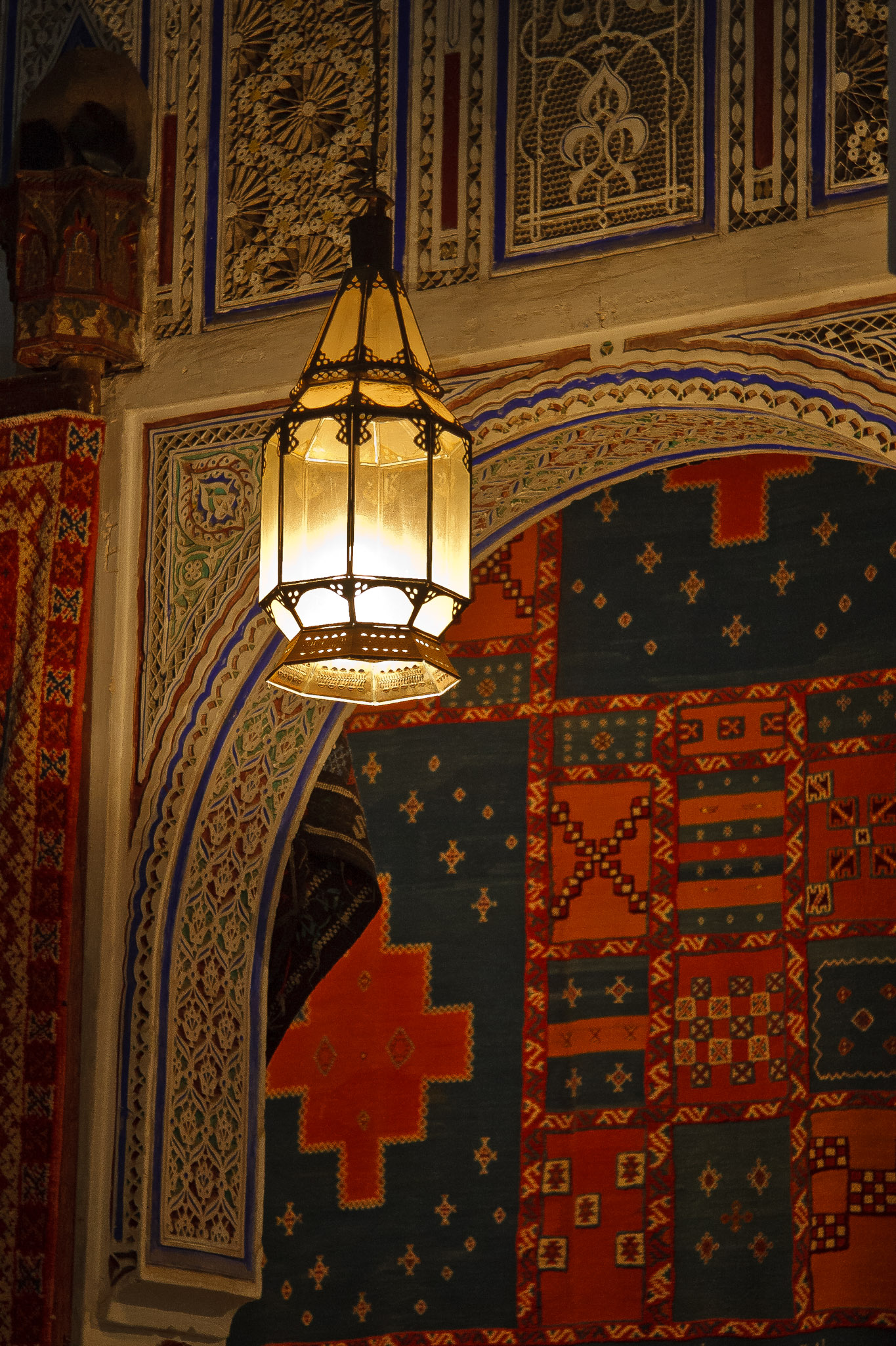 A lantern glowing in a Moroccan carpet shop
