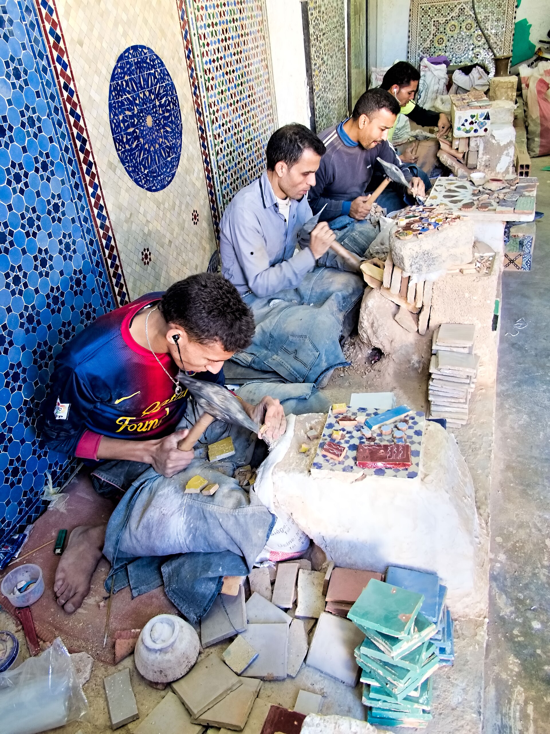 Craftsmen cutting zellige tiles in Fez